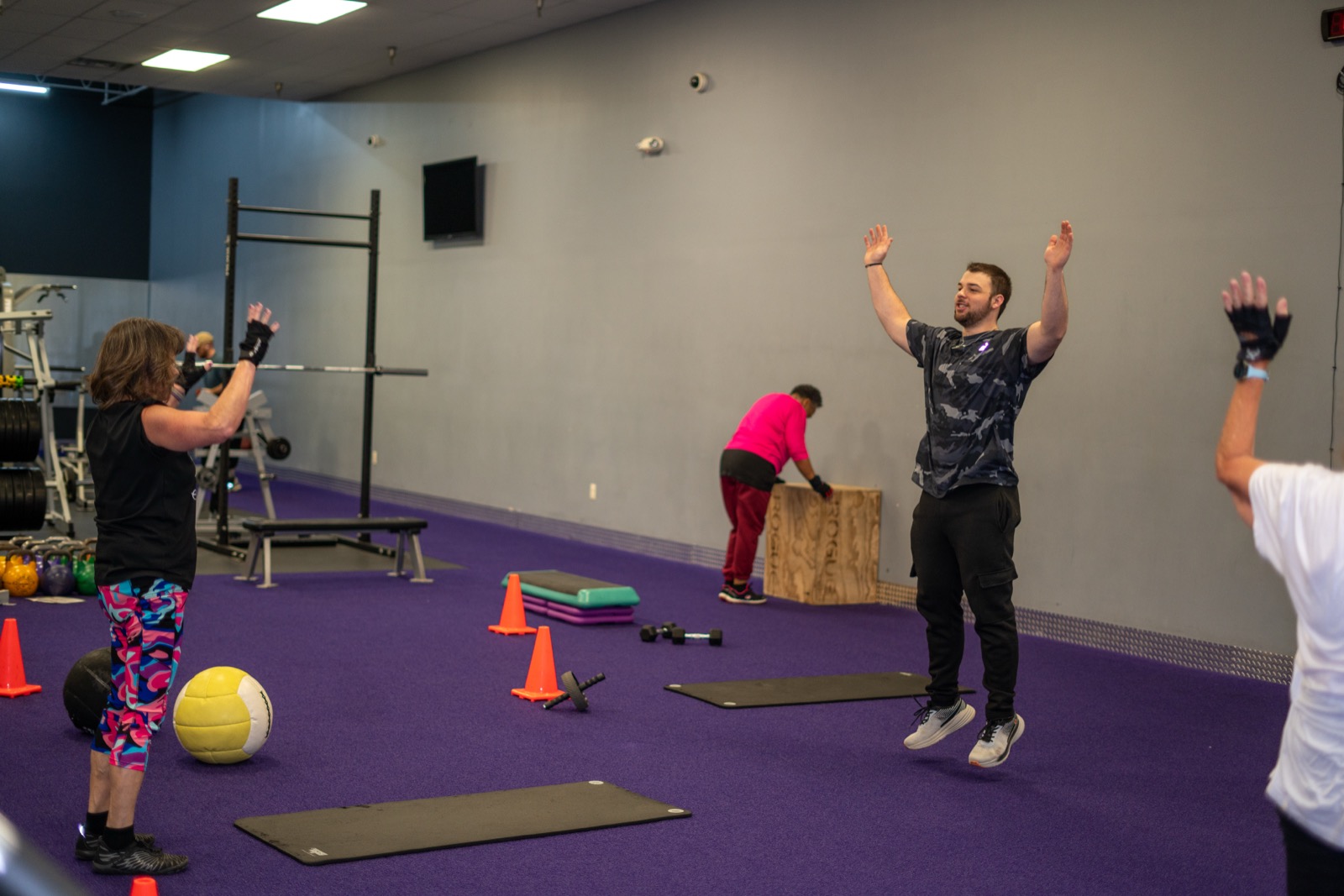 Group class doing overhead exercises